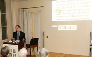 Professor Roger Stalley during his lecture with text from the Book of Kells in the background