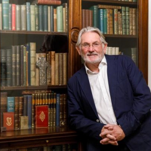 Professor Thomas Bartlett standing in front of Princess Grace's Personal Collection of Irish books